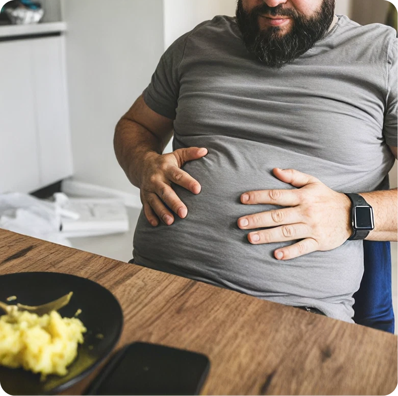 Person holding their stomach after a heavy meal